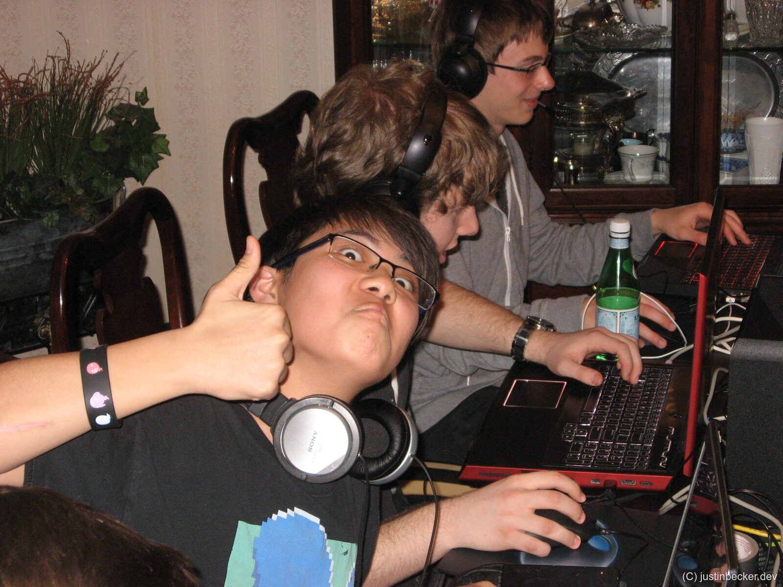 Kenny at a LAN party with chunky laptops in the background