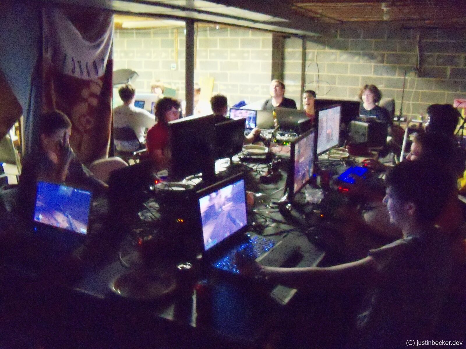 A dimly lit basement LAN party