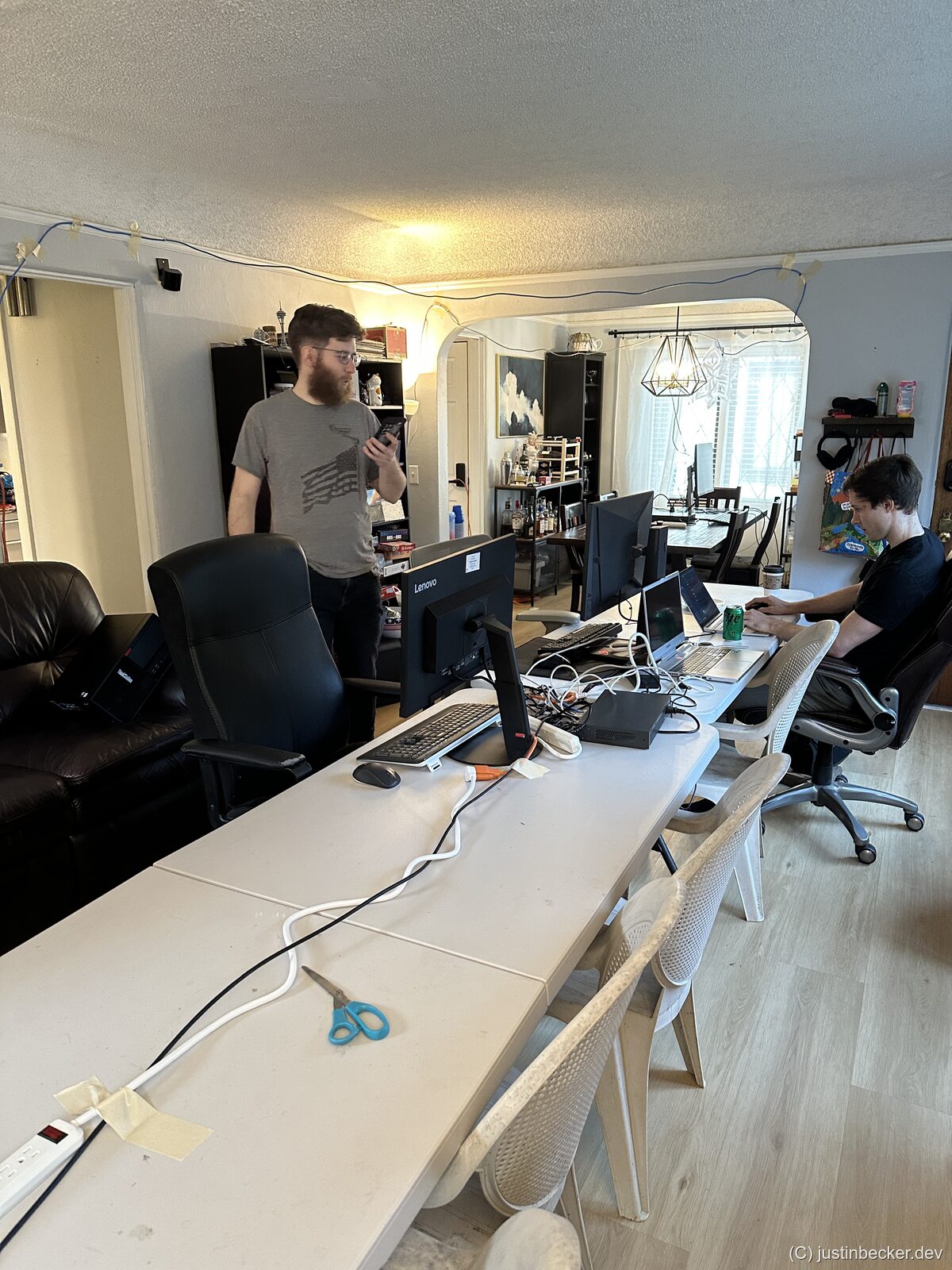Ethernet cables running through the gap between two folding tables